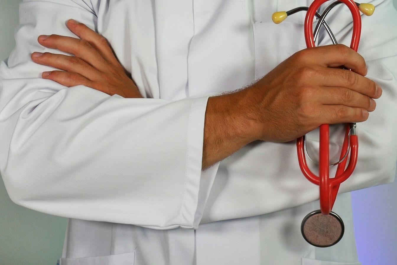 Confident doctor folding his arms