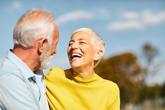 An older couple laughing, enjoying life